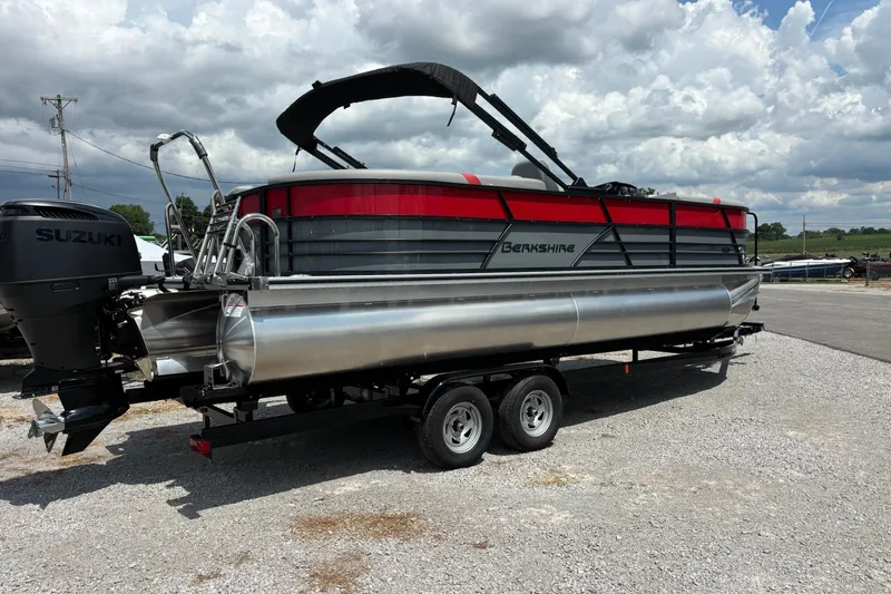 Slide: The Image of 2026 Berkshire 24RFX CTS pontoon boat on trailer, featuring Suzuki outboard motor. - 2