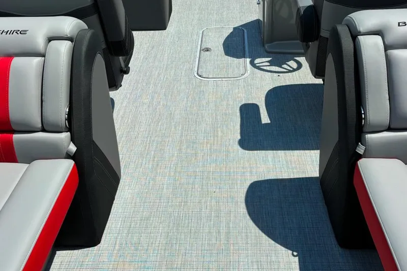 Slide: The Image of 2026 Berkshire 24RFX CTS boat interior with gray and red seating, textured flooring. - 3