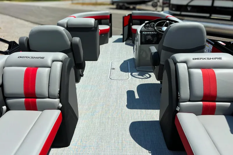 Slide: The Image of 2026 Berkshire 24RFX CTS boat interior with gray and red seating, steering console visible. - 4