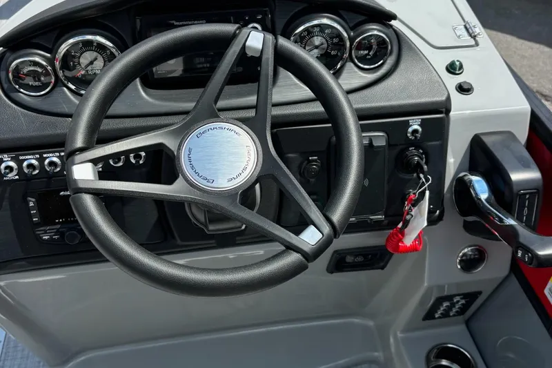 Slide: The Image of Steering console of 2026 Berkshire 24RFX CTS boat with gauges and controls. - 8