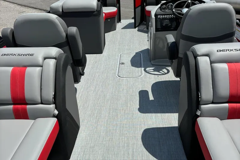 Slide: The Image of 2026 Berkshire 24RFX CTS boat interior with gray and red seating, steering console visible. - 9