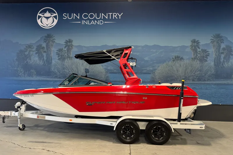 The Image of 2019 Nautique Super Air Nautique GS20 boat in showroom, red and white design. - 1