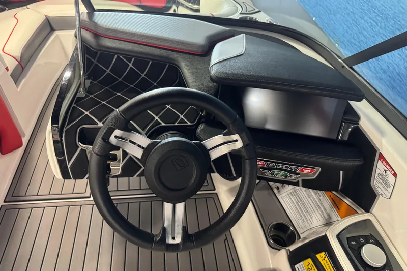 Slide: The Image of 2019 Nautique Super Air Nautique GS20 boat dashboard with steering wheel and controls. - 12