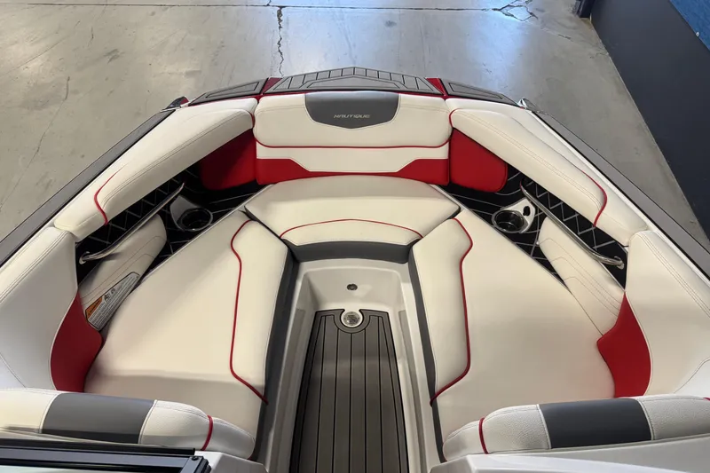 Slide: The Image of 2019 Nautique Super Air Nautique GS20 boat interior with red and white seating. - 14