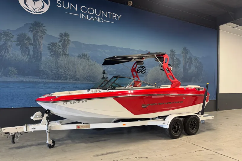 Slide: The Image of 2019 Nautique Super Air Nautique GS20 boat in showroom, red and white design. - 2