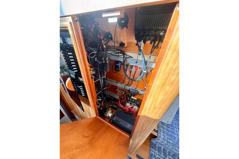 Slide: The Image of Electrical panel inside 2006 PDQ PowerCat boat, showcasing wiring and components. - 13