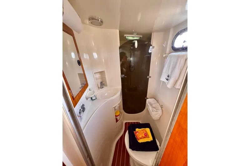 Slide: The Image of Compact bathroom in 2006 PDQ PowerCat boat with sink, mirror, and shower. - 18