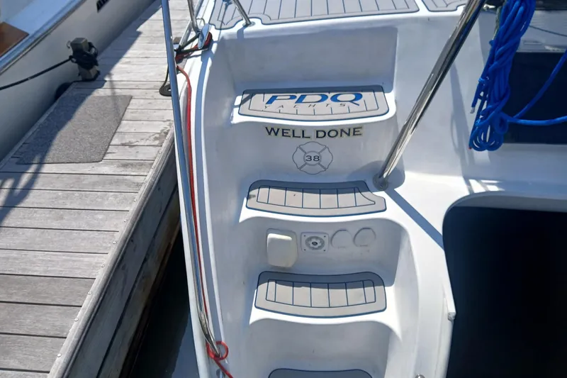Slide: The Image of 2006 PDQ PowerCat boat stern with "Well Done" and dock view. - 25
