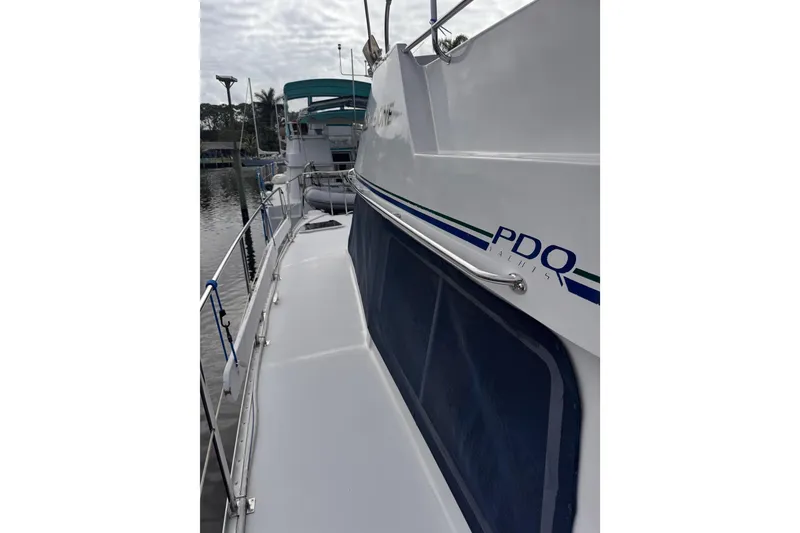 Slide: The Image of 2006 PDQ PowerCat yacht docked, featuring sleek design and railing details. - 26