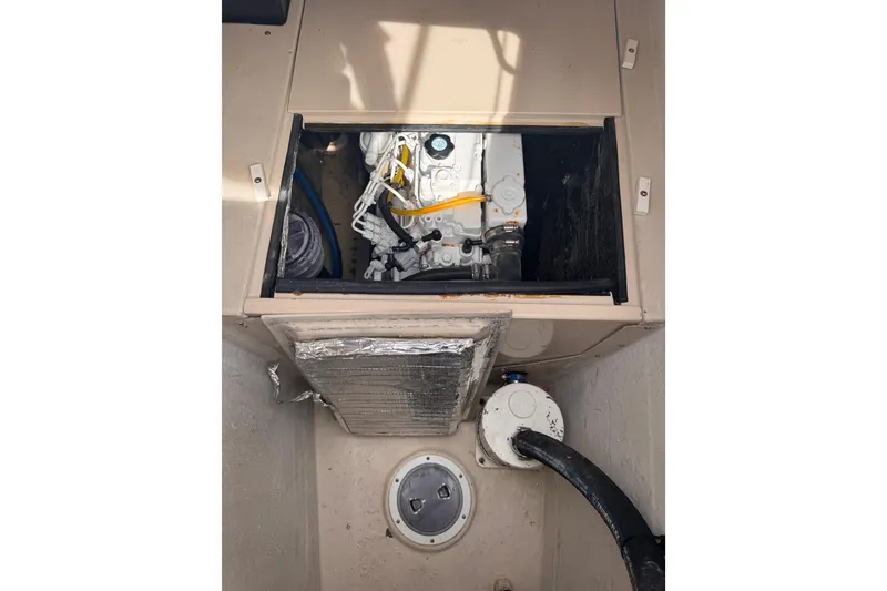 Slide: The Image of Engine compartment of a 2006 PDQ PowerCat boat, showcasing mechanical components. - 30