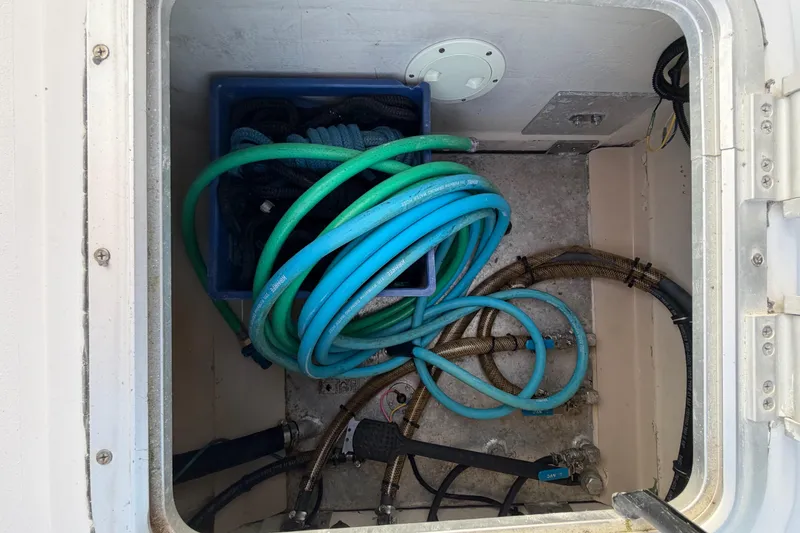 Slide: The Image of Storage compartment of 2006 PDQ PowerCat with coiled hoses and ropes. - 32