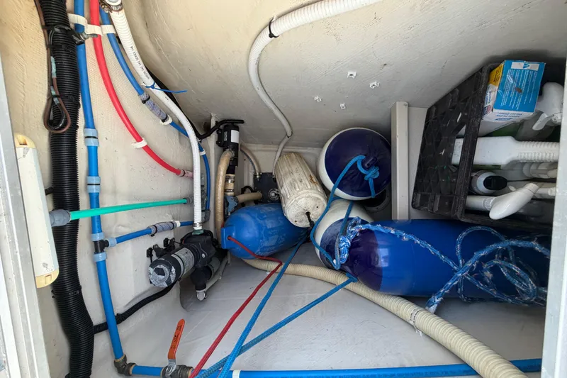 Slide: The Image of Interior of 2006 PDQ PowerCat showing plumbing and equipment storage. - 34
