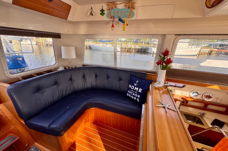 Slide: The Image of Interior of a 2006 PDQ PowerCat boat with cozy seating and nautical decor. - 5