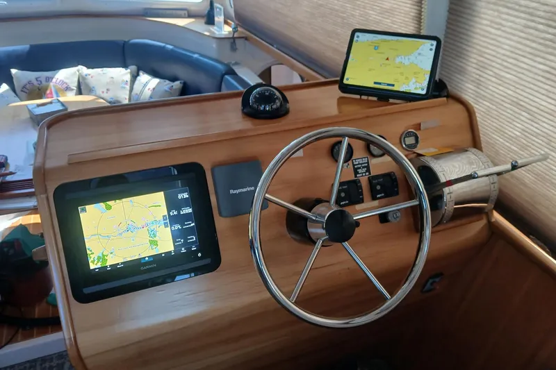 Slide: The Image of Steering console of 2006 PDQ PowerCat with navigation screens and controls. - 6