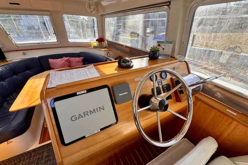 Slide: The Image of Interior of 2006 PDQ PowerCat boat with Garmin navigation and cozy seating area. - 7