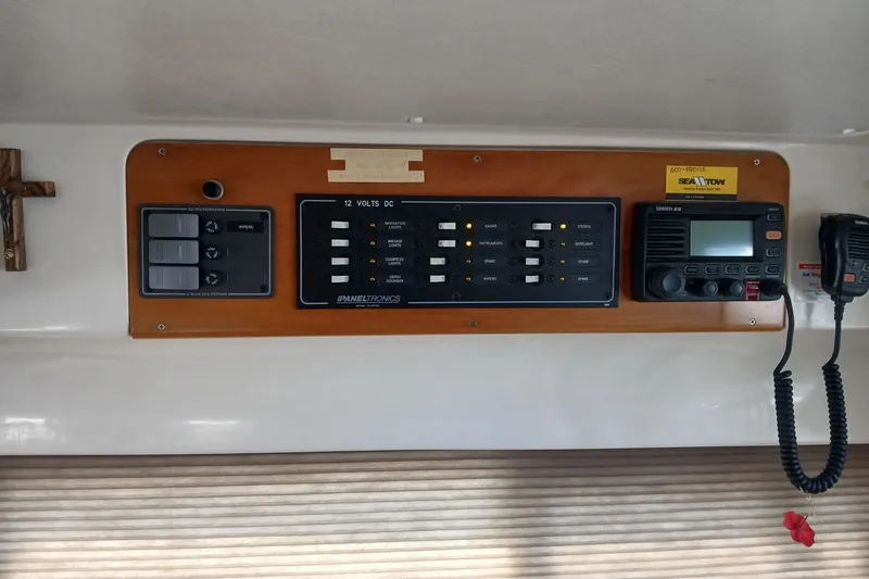 Slide: The Image of Control panel of a 2006 PDQ PowerCat boat with radio and switches. - 8