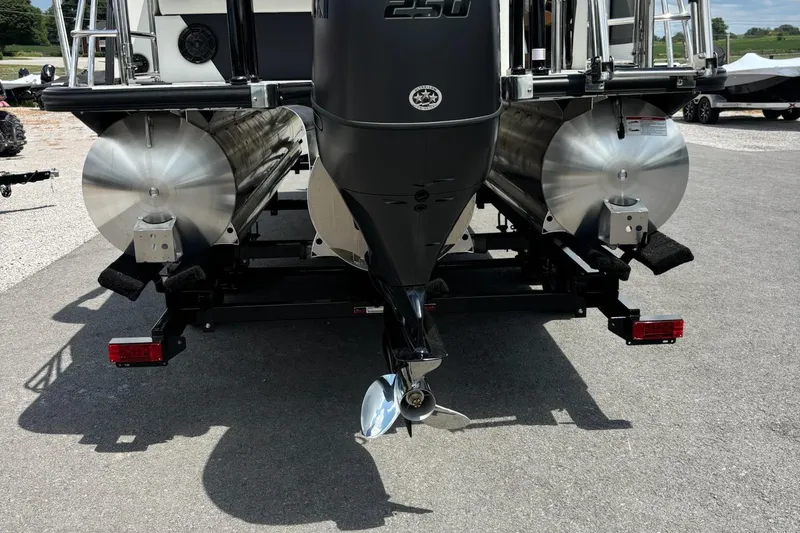 Slide: The Image of Rear view of 2026 Trifecta 23 ULE SS pontoon boat with dual pontoons and outboard motor. - 14