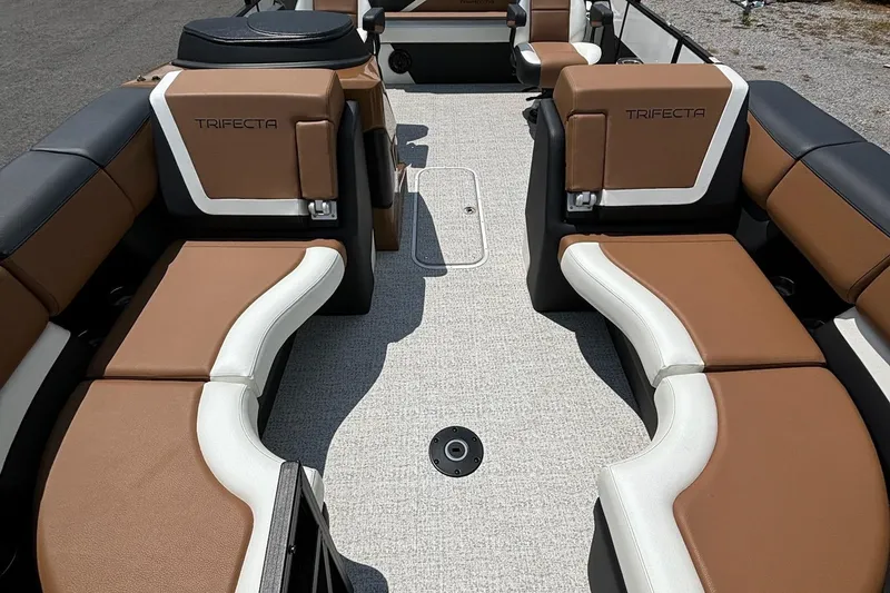 Slide: The Image of 2026 Trifecta 23 ULE SS boat interior with brown and white seating. - 2