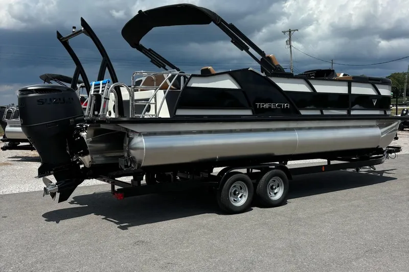 Slide: The Image of 2026 Trifecta 23 ULE SS pontoon boat on trailer, featuring Suzuki outboard motor. - 3