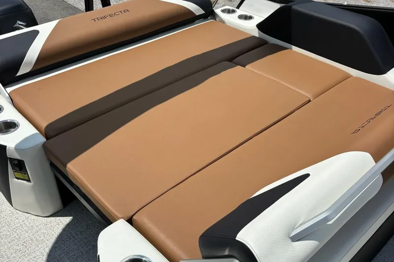 Slide: The Image of 2026 Trifecta 23 ULE SS boat with tan cushioned seating and cup holders. - 9