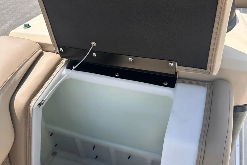 Slide: The Image of Open storage compartment in 2026 Trifecta 23 ULE SS boat with beige seating. - 11