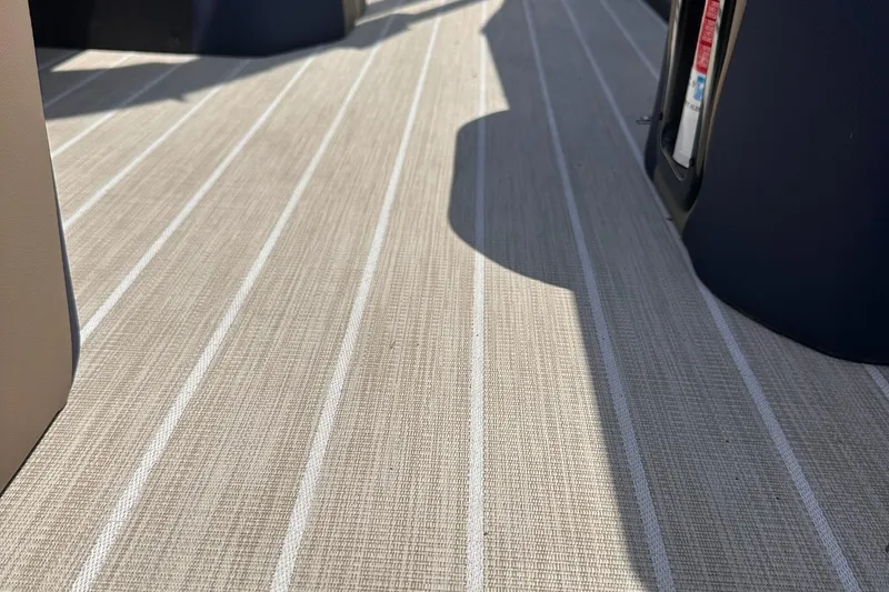 Slide: The Image of Beige striped flooring on 2026 Trifecta 23 ULE SS boat interior. - 13