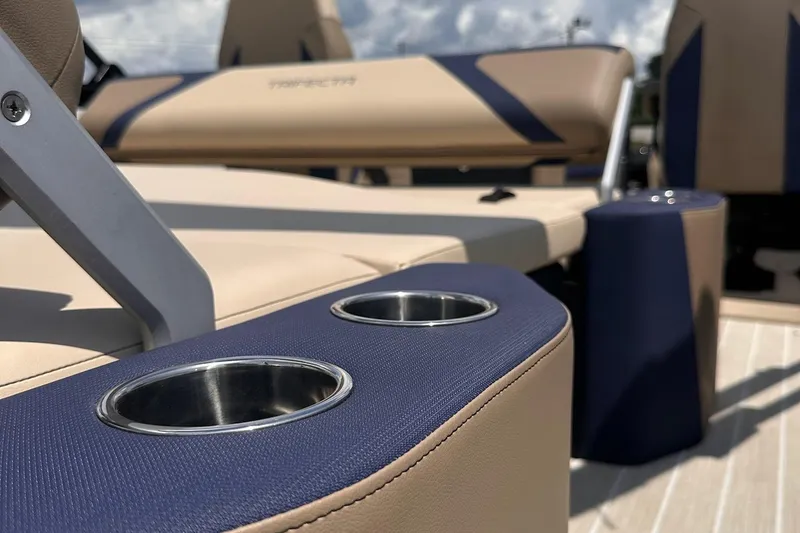 Slide: The Image of Luxurious seating and cup holders on 2026 Trifecta 23 ULE SS boat, featuring beige and navy design. - 15