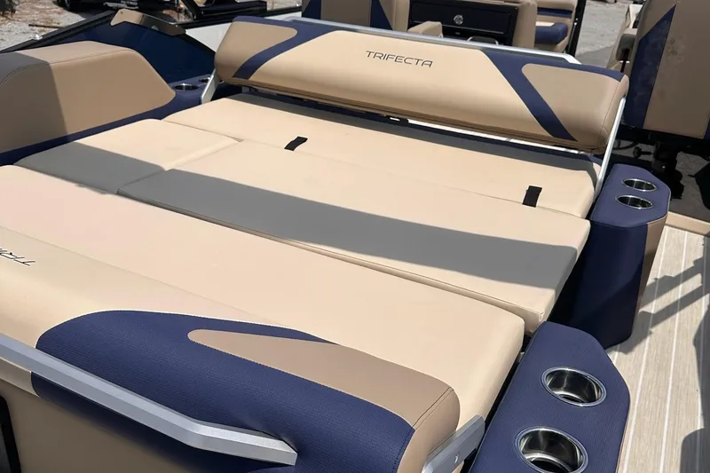 Slide: The Image of 2026 Trifecta 23 ULE SS boat interior with beige and navy seating, cup holders. - 5