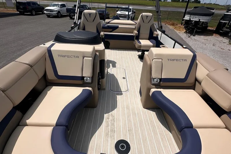 Slide: The Image of 2026 Trifecta 23 ULE SS pontoon boat interior with beige and navy seating. - 6