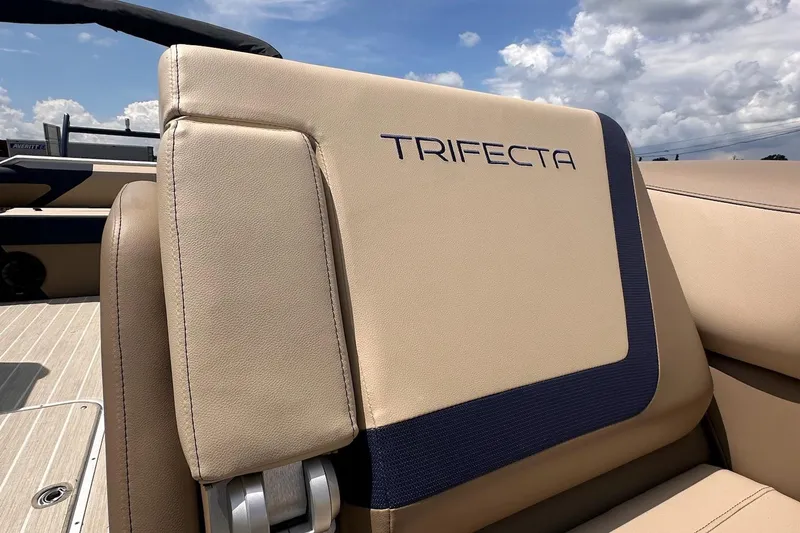 Slide: The Image of 2026 Trifecta 23 ULE SS boat seat with logo, beige upholstery, and blue accents. - 9