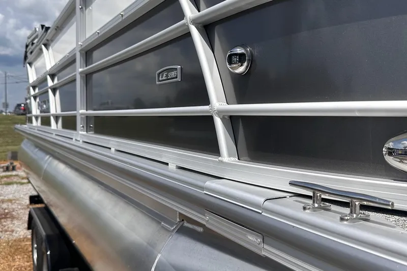Slide: The Image of 2026 Trifecta 22 RF LE pontoon boat, sleek aluminum design, side view. - 10