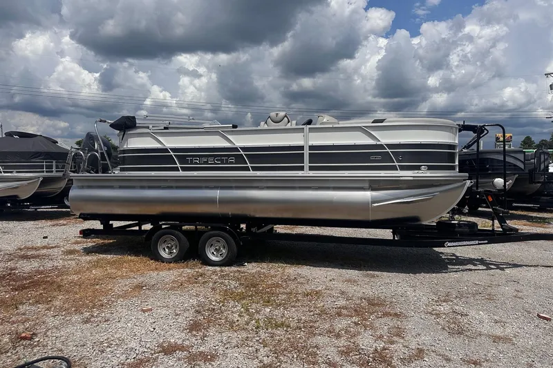 Slide: The Image of 2026 Trifecta 22 RF LE pontoon boat on trailer under cloudy sky. - 12
