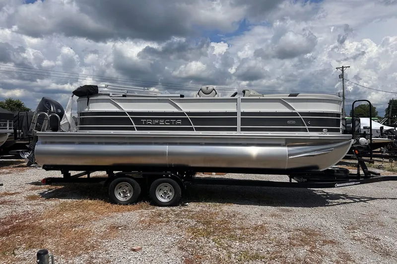 Slide: The Image of 2026 Trifecta 22 RF LE pontoon boat on trailer under cloudy sky. - 14