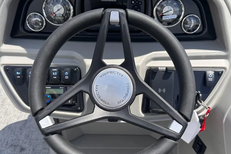 Slide: The Image of Steering wheel of 2026 Trifecta 22 RF LE boat with dashboard controls and gauges. - 3