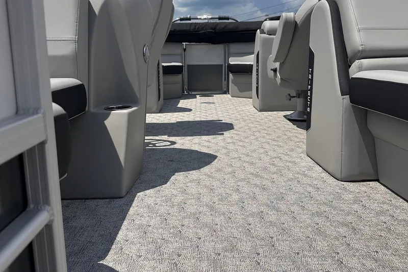 Slide: The Image of Interior of 2026 Trifecta 22 RF LE pontoon boat with gray seating and carpet. - 9