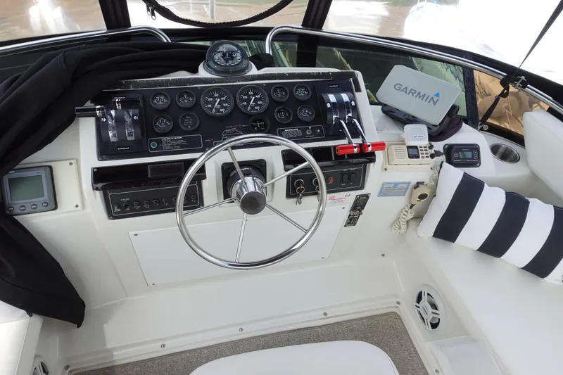 Slide: The Image of 1993 Silverton 31 Convertible helm with steering wheel, gauges, and Garmin navigation system. - 14