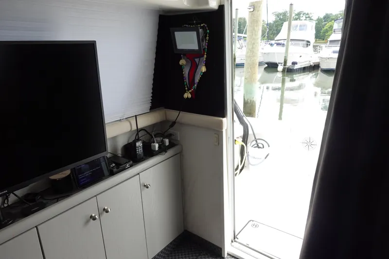 Slide: The Image of Interior view of 1993 Silverton 31 Convertible yacht with marina in background. - 19