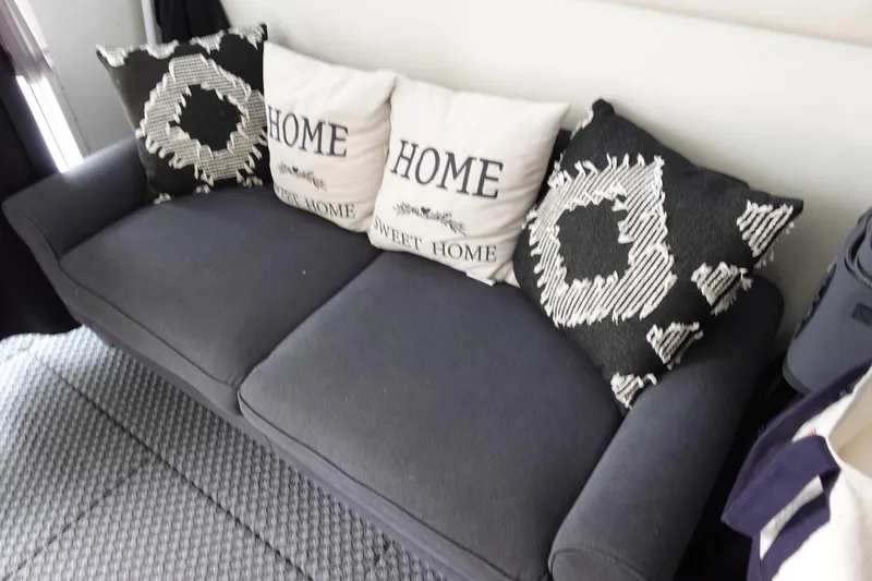 Slide: The Image of Gray sofa with patterned and "Home Sweet Home" pillows, inside 1993 Silverton 31 Convertible. - 22