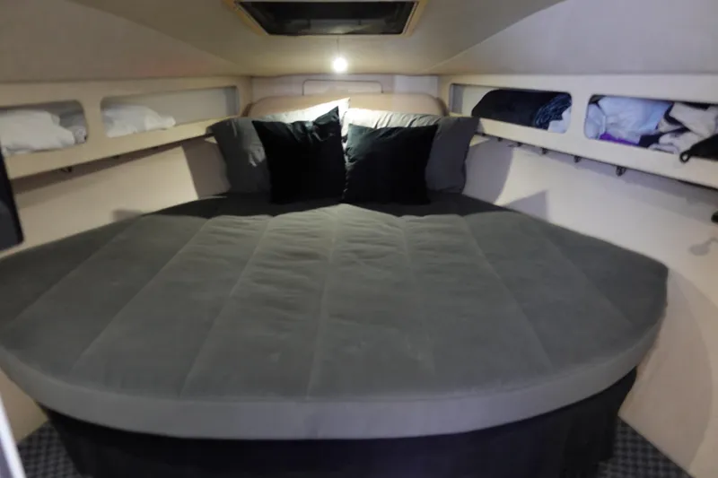 Slide: The Image of Cozy cabin interior of 1993 Silverton 31 Convertible boat with comfortable bedding. - 24