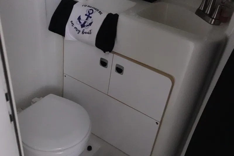 Slide: The Image of 1993 Silverton 31 Convertible boat bathroom with toilet and sink. - 27