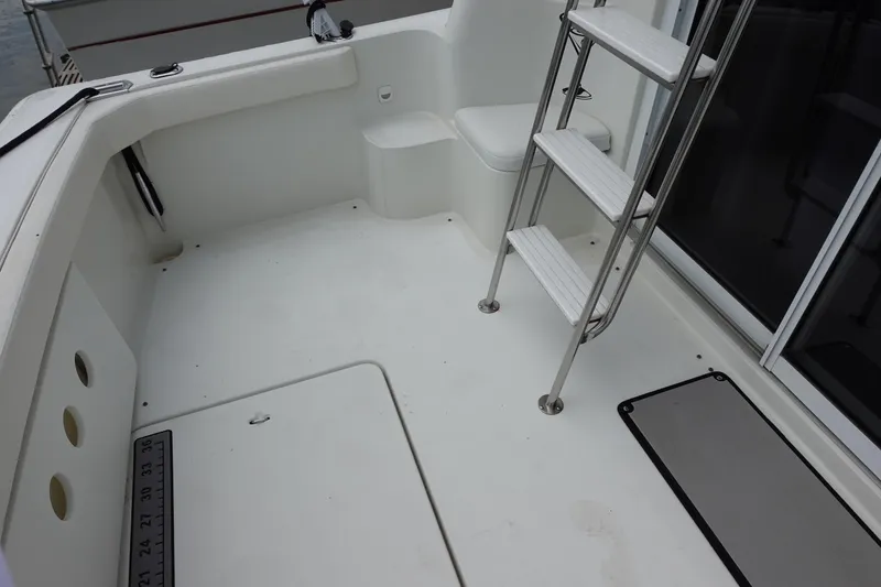 Slide: The Image of 1993 Silverton 31 Convertible boat deck with ladder and seating area. - 8