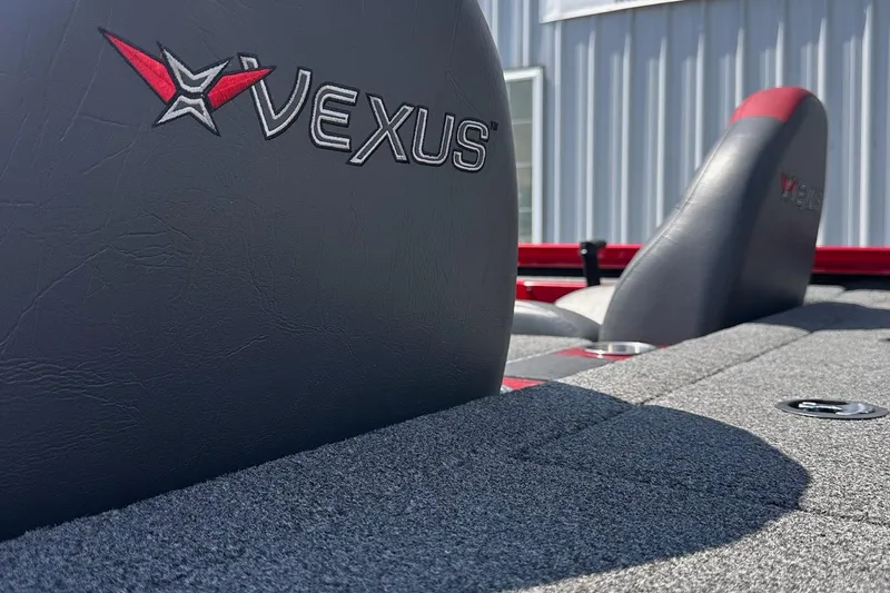 Slide: The Image of 2021 Vexus AVX181 boat interior with logo on gray seats, showcasing sleek design. - 12