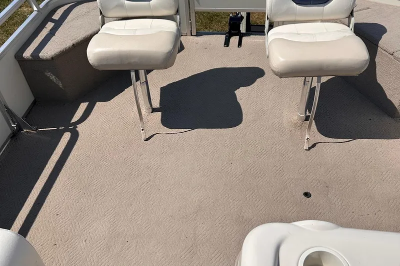 Slide: The Image of 2008 Sun Tracker FISHIN' BARGE 21 interior with two white seats and carpeted floor. - 20