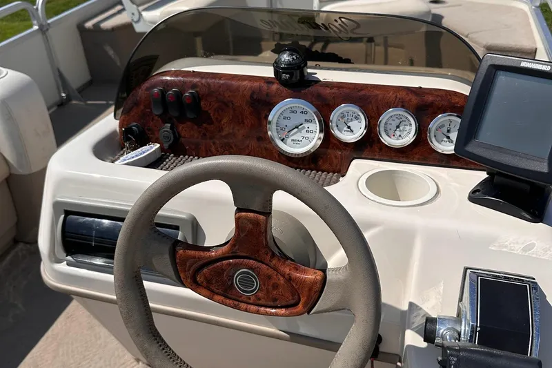 Slide: The Image of 2008 Sun Tracker FISHIN' BARGE 21 Signature Series dashboard with steering wheel and gauges. - 21