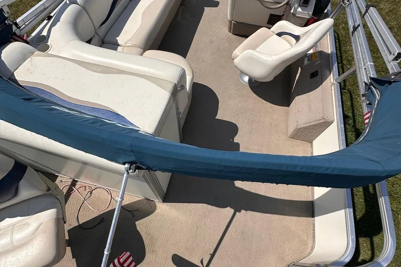 Slide: The Image of 2008 Sun Tracker FISHIN' BARGE 21 interior with seating and steering area. - 23