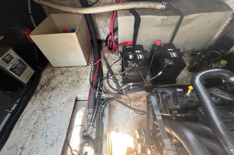 Slide: The Image of Engine compartment of a 2004 Rinker Fiesta Vee 270 with batteries and wiring. - 20