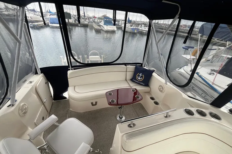 Slide: The Image of 2004 Rinker Fiesta Vee 270 boat docked in marina, surrounded by other sailboats. - 5
