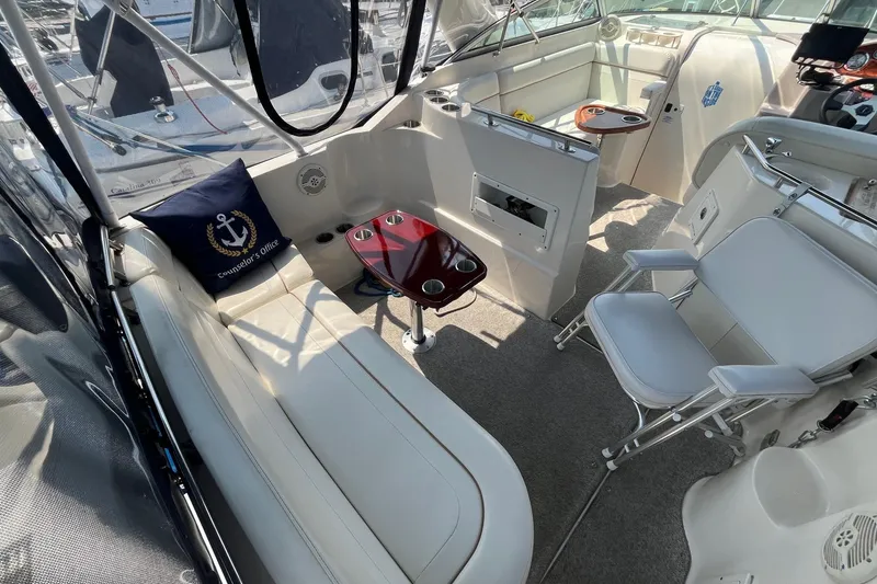 Slide: The Image of 2004 Rinker Fiesta Vee 270 boat docked at marina with clear canopy and blue skies. - 6