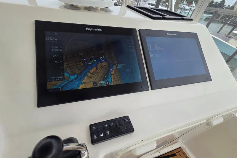 Slide: The Image of Raymarine navigation screens on 2004 Ocean Yachts 43 Super Sport boat dashboard. - 16