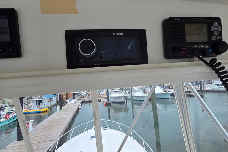 Slide: The Image of 2004 Ocean Yachts 43 Super Sport dashboard with marine electronics at a marina. - 23